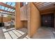 Inviting home entrance with rustic accents, stone-tiled floor, and outdoor dining area at 7401 N Scottsdale Rd # 24, Paradise Valley, AZ 85253