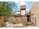 Modern exterior featuring stucco walls, pergola, gated entry, and unique architectural design at 7401 N Scottsdale Rd # 24, Paradise Valley, AZ 85253