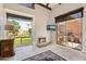 Bright living room with fireplace, large window, and sliding glass door to patio at 7401 N Scottsdale Rd # 24, Paradise Valley, AZ 85253