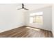 Inviting bedroom with wood floors, white walls, and natural light from the large window at 747 W Rice Dr, Tempe, AZ 85283