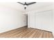 Clean bedroom with wood floors, white walls, ceiling fan, and closet, providing a cozy space at 747 W Rice Dr, Tempe, AZ 85283