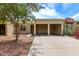 Charming home exterior with desert landscaping, covered parking, and a welcoming entrance at 747 W Rice Dr, Tempe, AZ 85283