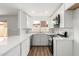 Bright kitchen with white cabinets, stainless steel appliances, and wood-look flooring at 747 W Rice Dr, Tempe, AZ 85283