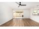 Bright living room with wood flooring, ceiling fan, and sliding glass doors for natural light at 747 W Rice Dr, Tempe, AZ 85283