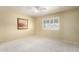 Bedroom with carpet floors, neutral paint and natural light through a large window at 8011 E Milagro Ave, Mesa, AZ 85209