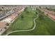 Scenic aerial view of a lush golf course with mature trees, smooth greens, and winding pathways at 8011 E Milagro Ave, Mesa, AZ 85209