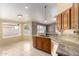A charming kitchen featuring granite countertops, stainless steel appliances, and an open design at 8011 E Milagro Ave, Mesa, AZ 85209
