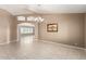 Open concept living room with tiled floors, decorative lighting, and arched entryways at 8011 E Milagro Ave, Mesa, AZ 85209