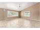 Bright living room with tile floors, ceiling fan, and plantation shutters on the windows at 8011 E Milagro Ave, Mesa, AZ 85209