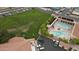 Aerial view of a community pool surrounded by lush landscaping and comfortable lounge chairs for relaxation at 8011 E Milagro Ave, Mesa, AZ 85209