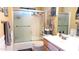 Bathroom featuring a shower-tub combination with decorated glass door and a wood vanity at 8020 E Keats Ave # 279, Mesa, AZ 85209