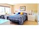 Cozy bedroom featuring a comfortable bed, tiled floor, and natural light from the window at 8020 E Keats Ave # 279, Mesa, AZ 85209