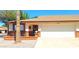 Charming home featuring a light colored garage door, brick accents, and a cozy front patio area at 8020 E Keats Ave # 279, Mesa, AZ 85209