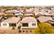 An aerial view shows well-maintained homes, tile roofs, and desert landscaping in this desirable neighborhood at 9229 W Willow Bend Ln, Phoenix, AZ 85037