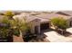 Aerial view of a single-story home with a brown roof, desert landscaping, and a two-car garage at 9229 W Willow Bend Ln, Phoenix, AZ 85037