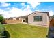 Great backyard with patio, block wall and green grass is perfect for outdoor activities and relaxation at 9229 W Willow Bend Ln, Phoenix, AZ 85037