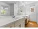 Primary bathroom featuring dual sinks, a large mirror and cabinetry with modern fixtures at 9229 W Willow Bend Ln, Phoenix, AZ 85037