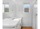 Clean and bright bathroom featuring a single sink, white cabinets, and modern fixtures at 9229 W Willow Bend Ln, Phoenix, AZ 85037