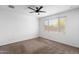 Clean bedroom with standard window, ceiling fan, wall plugs, and baseboard at 9229 W Willow Bend Ln, Phoenix, AZ 85037