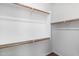This is a walk-in closet with white walls, shelving, and hanging rods at 9229 W Willow Bend Ln, Phoenix, AZ 85037