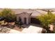 The house showcases a well-manicured yard, complemented by the home's inviting facade and cozy entrance at 9229 W Willow Bend Ln, Phoenix, AZ 85037