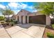 Charming single-story home with stucco exterior, arched entryway, and well-manicured landscaping at 9229 W Willow Bend Ln, Phoenix, AZ 85037