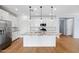 Bright kitchen featuring white cabinets, stainless steel appliances, an island and modern pendant lighting at 9229 W Willow Bend Ln, Phoenix, AZ 85037