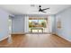 Bright living room with wood floors, a ceiling fan, and sliding glass doors with backyard views at 9229 W Willow Bend Ln, Phoenix, AZ 85037
