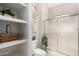 Bright bathroom featuring a glass enclosed shower, toilet, and built-in shelving at 9253 N Firebrick Dr # 206, Fountain Hills, AZ 85268