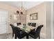 Formal dining room with glass table and seating for six, featuring modern chandelier and natural lighting at 9253 N Firebrick Dr # 206, Fountain Hills, AZ 85268