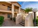 Two-story condo building with outdoor staircases and desert landscaping at 9253 N Firebrick Dr # 206, Fountain Hills, AZ 85268