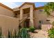Two-story condo building featuring desert landscaping and a private stairwell leading to the second floor units at 9253 N Firebrick Dr # 206, Fountain Hills, AZ 85268