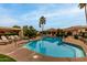 Community pool with lounge chairs and palm trees at 9253 N Firebrick Dr # 206, Fountain Hills, AZ 85268