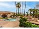 Community spa features palm trees, a rock water feature, and lush landscaping at 9253 N Firebrick Dr # 206, Fountain Hills, AZ 85268
