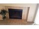 Close up of a fireplace with tile surround and a potted plant on the hearth at 930 N Mesa Dr # 2027, Mesa, AZ 85201
