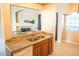 Open kitchen featuring granite countertops, stainless steel sink, and breakfast bar seating area at 930 N Mesa Dr # 2027, Mesa, AZ 85201