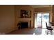 Bright living room features fireplace, neutral carpeting, and sliding glass doors to outdoor space at 930 N Mesa Dr # 2027, Mesa, AZ 85201