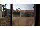 Patio view from the unit shows neighborhood buildings and desert landscaping at 930 N Mesa Dr # 2027, Mesa, AZ 85201