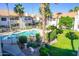 Community pool and spa surrounded by lush landscaping and palm trees add resort-style living at 930 N Mesa Dr # 2027, Mesa, AZ 85201