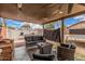 Back patio is covered and furnished with a wicker couch and other seating with a beautiful blue sky at 10723 N 80Th Ln, Peoria, AZ 85345
