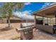 Backyard with a stainless steel BBQ grill, brick flooring, and outdoor furniture at 10723 N 80Th Ln, Peoria, AZ 85345