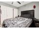 A gray bedroom features a bed with monochrome sheets, a ceiling fan, and a closet at 10723 N 80Th Ln, Peoria, AZ 85345