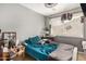 A bedroom features a bed with teal sheets, a ceiling fan, and a wooden desk at 10723 N 80Th Ln, Peoria, AZ 85345