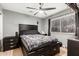 Bedroom features a bed with monochrome sheets, a ceiling fan, and a tiled floor at 10723 N 80Th Ln, Peoria, AZ 85345