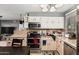 A kitchen features stainless steel appliances, tiled backsplash, and ample counter space at 10723 N 80Th Ln, Peoria, AZ 85345