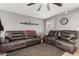 Cozy living room with tile flooring, ceiling fan, and comfortable seating for relaxation at 10723 N 80Th Ln, Peoria, AZ 85345
