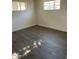 Light and airy bedroom featuring two windows and wood flooring at 120 N Jackson St, Chandler, AZ 85225