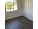 Comfortable bedroom featuring neutral walls, and wood flooring at 120 N Jackson St, Chandler, AZ 85225