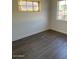 Neutral bedroom featuring two windows, and wood flooring at 120 N Jackson St, Chandler, AZ 85225