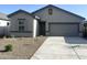 A charming single-story home with a well-manicured front yard and a two-car garage at 13193 E Verbina Ln, Florence, AZ 85132